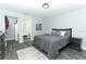 This bedroom features a gray wood floor, ensuite bathroom, closet, and gray color scheme at 1077 Dees Dr, Oviedo, FL 32765