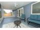 Relaxing screened porch featuring comfortable seating, ceiling fan, and painted concrete floors at 1077 Dees Dr, Oviedo, FL 32765