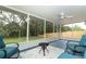 Covered and screened porch area that has a view to the green grass and wooded backyard at 1077 Dees Dr, Oviedo, FL 32765