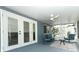 Comfortable screened in porch with a ceiling fan and view to yard through the screens at 1077 Dees Dr, Oviedo, FL 32765