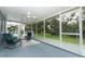 Screened porch with view to the lawn and surrounding landscape with mature trees and foliage at 1077 Dees Dr, Oviedo, FL 32765