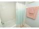The bathroom features a shower with a modern shower curtain and bright lighting at 1077 Dees Dr, Oviedo, FL 32765