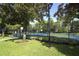 Community tennis and basketball courts with fresh blue playing surface and perimeter landscaping at 1077 Dees Dr, Oviedo, FL 32765