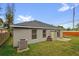 Home's backyard featuring a storage shed, concrete patio, and lawn area at 10930 Buckwater Ct, Orlando, FL 32817