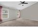 Bright bedroom with ceiling fan, neutral walls, and two windows at 10930 Buckwater Ct, Orlando, FL 32817