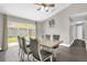 Open dining room with hardwood floors, neutral paint, modern decor, and a large window with sliding glass doors at 10930 Buckwater Ct, Orlando, FL 32817