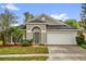 Charming single-story home featuring a manicured lawn, two-car garage and an inviting front entrance at 10930 Buckwater Ct, Orlando, FL 32817