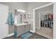 Bright main bathroom with gray vanity and walk-in closet at 10930 Buckwater Ct, Orlando, FL 32817