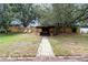 Spacious backyard with a charming gazebo, mature trees, and a swing, offering a tranquil outdoor retreat at 11512 Clair Pl, Clermont, FL 34711