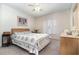 Cozy bedroom with ceiling fan, neutral walls, and a comfortable-looking bed, creating a relaxing atmosphere at 11512 Clair Pl, Clermont, FL 34711