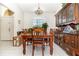 Cozy dining room featuring tile flooring, wooden furniture, and a chandelier at 11512 Clair Pl, Clermont, FL 34711