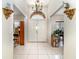Spacious foyer with tile flooring, a decorative chandelier, and a view into other rooms at 11512 Clair Pl, Clermont, FL 34711