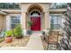 Inviting front entrance with double doors, a decorative archway, and manicured landscaping at 11512 Clair Pl, Clermont, FL 34711