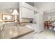 Functional kitchen featuring stone countertops and white cabinetry at 11512 Clair Pl, Clermont, FL 34711