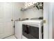 Efficient laundry room with modern washer and dryer, shelving, and ample storage space, perfect for household tasks at 11512 Clair Pl, Clermont, FL 34711