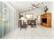 Inviting living room with tile floors, a ceiling fan, and a large window at 11512 Clair Pl, Clermont, FL 34711