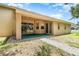 Inviting covered patio with brick walkway offers an ideal outdoor space for relaxation and entertaining, accessible via sliding doors at 11512 Clair Pl, Clermont, FL 34711