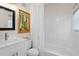 Bright bathroom featuring a modern vanity, framed mirror, and a tub-shower combo with white tile at 11520 Churchill St, Orlando, FL 32817