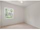 Simple room features tile flooring and a window providing ample light and a view at 11520 Churchill St, Orlando, FL 32817