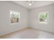 Bedroom with tile flooring, ceiling fan, and natural light from the two bright windows at 11520 Churchill St, Orlando, FL 32817