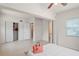 Bright bedroom with tile floors, a ceiling fan, and closet storage at 11520 Churchill St, Orlando, FL 32817