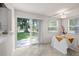 Dining area with sliding glass doors to the backyard, bright windows, and neutral tile flooring at 11520 Churchill St, Orlando, FL 32817