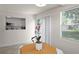 Bright dining area with natural light, modern lighting fixture, and tile flooring at 11520 Churchill St, Orlando, FL 32817