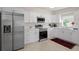 Well-lit kitchen featuring stainless steel appliances, ample counter space, and white cabinetry at 11520 Churchill St, Orlando, FL 32817
