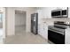 Modern kitchen with stainless steel appliances, white cabinets, and an open floorplan at 11520 Churchill St, Orlando, FL 32817