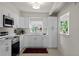Bright kitchen with white cabinets, stainless steel appliances, and a window offering natural light at 11520 Churchill St, Orlando, FL 32817