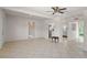 Spacious living room with tile floors and open layout, leading to the kitchen and other areas of the home at 11520 Churchill St, Orlando, FL 32817