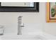 Close-up of a modern waterfall faucet on a white countertop with a decorative candle nearby at 11520 Churchill St, Orlando, FL 32817