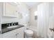 Bathroom with a shower-tub combo, white cabinets and a dark countertop sink at 1225 Golfview St, Orlando, FL 32804