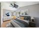 Staged bedroom with bed, fan, end tables, lamps, and artwork at 1225 Golfview St, Orlando, FL 32804