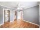 Charming bedroom featuring hardwood floors, a ceiling fan, gray walls, and two walk-in closets at 1225 Golfview St, Orlando, FL 32804