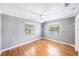Bedroom with fan, wood floors and natural light from two windows at 1225 Golfview St, Orlando, FL 32804