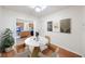 Staged dining room with hardwood floors, modern decor, and kitchen view at 1225 Golfview St, Orlando, FL 32804