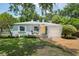 Charming house with landscaped front yard, yellow front door, and brick driveway at 1225 Golfview St, Orlando, FL 32804