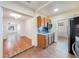 View from the kitchen into the living area showing wood floors and archways at 1225 Golfview St, Orlando, FL 32804