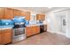 Updated kitchen with stainless steel appliances, and bright blue backsplash at 1225 Golfview St, Orlando, FL 32804