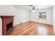 Open living room featuring hardwood floors, brick fireplace, and a bright window view at 1225 Golfview St, Orlando, FL 32804