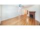 Bright, empty living room with hardwood floors, a ceiling fan, and a brick fireplace at 1225 Golfview St, Orlando, FL 32804