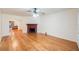 Spacious living room with hardwood floors, ceiling fan, and a brick fireplace at 1225 Golfview St, Orlando, FL 32804