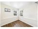 Empty room with wood floors, two windows, and stained glass at 1225 Golfview St, Orlando, FL 32804