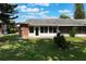 Lush backyard features a patio, mature trees, and well-maintained lawn, perfect for outdoor enjoyment at 1230 Americana Pl, Orlando, FL 32807
