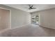 Bedroom with neutral carpet and sliding glass door to porch at 1230 Americana Pl, Orlando, FL 32807