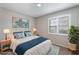 Inviting bedroom with calming colors, a cozy bed, and a scenic artwork at 1230 Americana Pl, Orlando, FL 32807