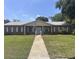 Charming brick home with manicured lawn, mature landscaping, and inviting front entrance at 1230 Americana Pl, Orlando, FL 32807