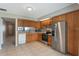 Efficient kitchen with stainless steel appliances and ample wood cabinetry at 1230 Americana Pl, Orlando, FL 32807
