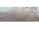 Empty living room with neutral carpeting and walls, offering a blank canvas for personalization at 1230 Americana Pl, Orlando, FL 32807